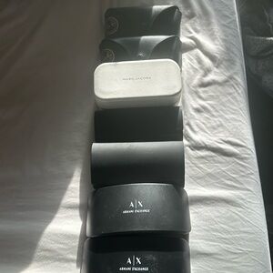 7 sunglasses cases. 2 Ray Bans, 2 Armani Exchange, 2 Carrera, 1 Marc Jacobs.